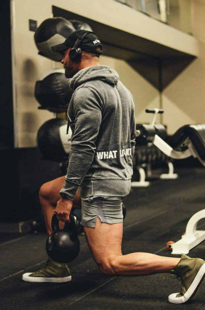 male doing lunger with dumbell